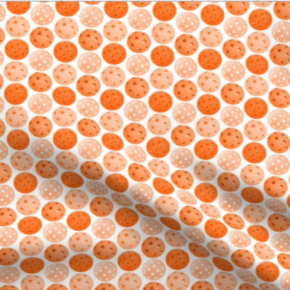 Pickleball Balls Orange Pickleball Balls on White Fabric